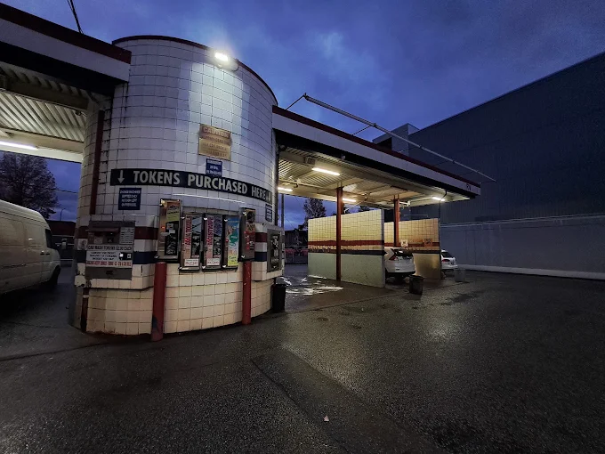 Car wash token booth lit up at night