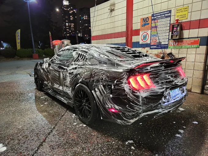 Ford Mustang covered in foam during a night wash